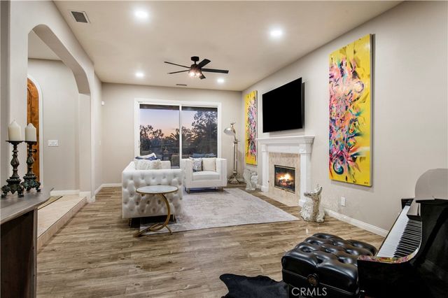 a living room with furniture fireplace and flat screen tv