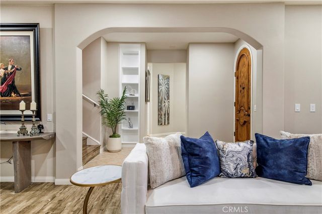 a large bed sitting in a living room and a mirror