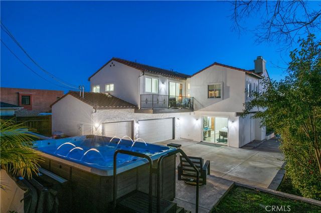 a view of a house with backyard and a fire pit