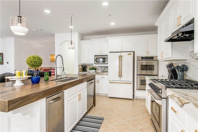 a kitchen with refrigerator a stove and cabinets