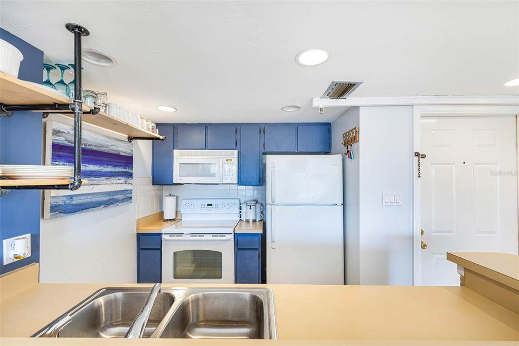 3160 Matecumbe Key Road, Unit 221 Punta Gorda, FL 33955 - Photo 11 of 26 a kitchen with stainless steel appliances a refrigerator sink and cabinets