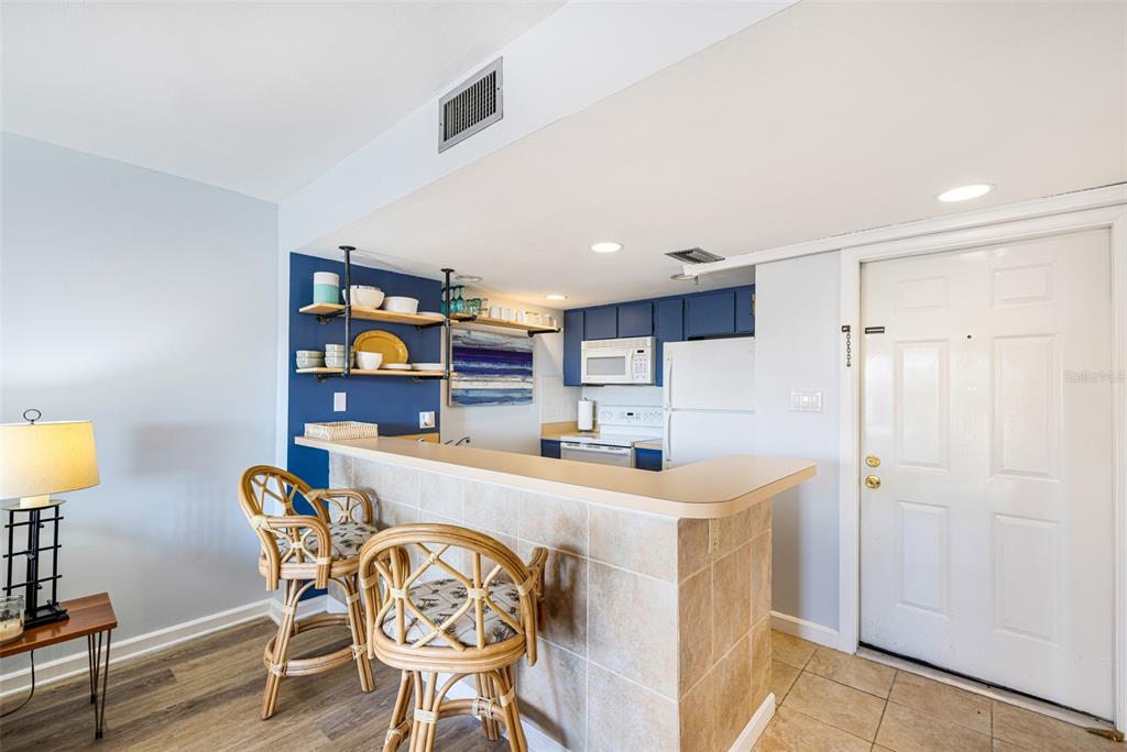 3160 Matecumbe Key Road, Unit 221 Punta Gorda, FL 33955 - Photo 14 of 26 a kitchen with stainless steel appliances granite countertop a dining table chairs and a refrigerator