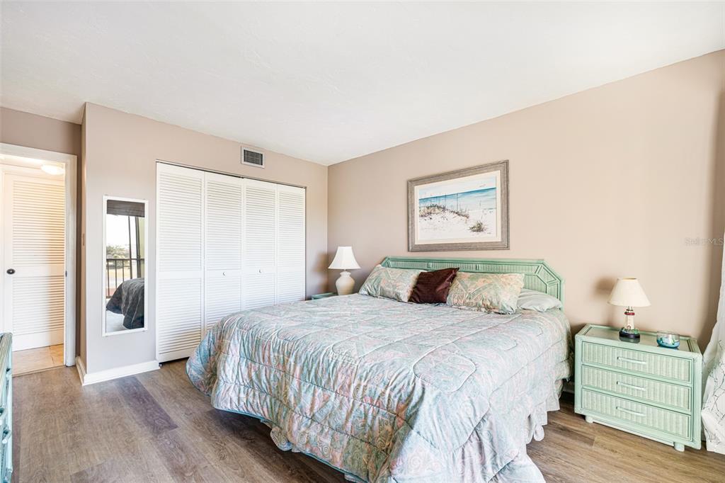 3160 Matecumbe Key Road, Unit 221 Punta Gorda, FL 33955 - Photo 17 of 26 a bedroom with a bed and a painting on the wall