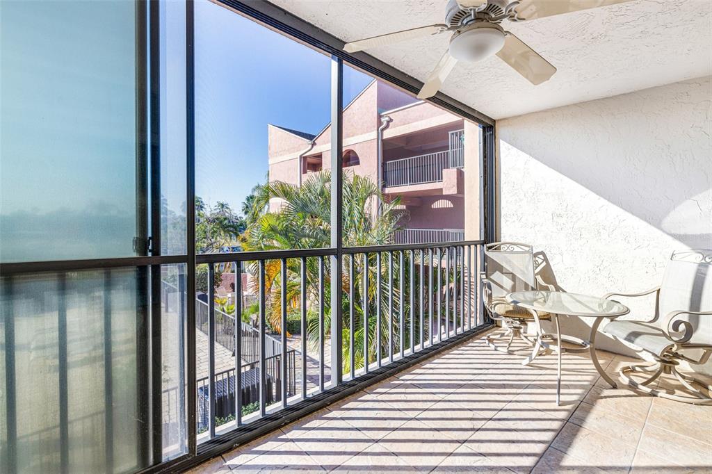 3160 Matecumbe Key Road, Unit 221 Punta Gorda, FL 33955 - Photo 20 of 26 a view of a balcony with furniture and wooden floor