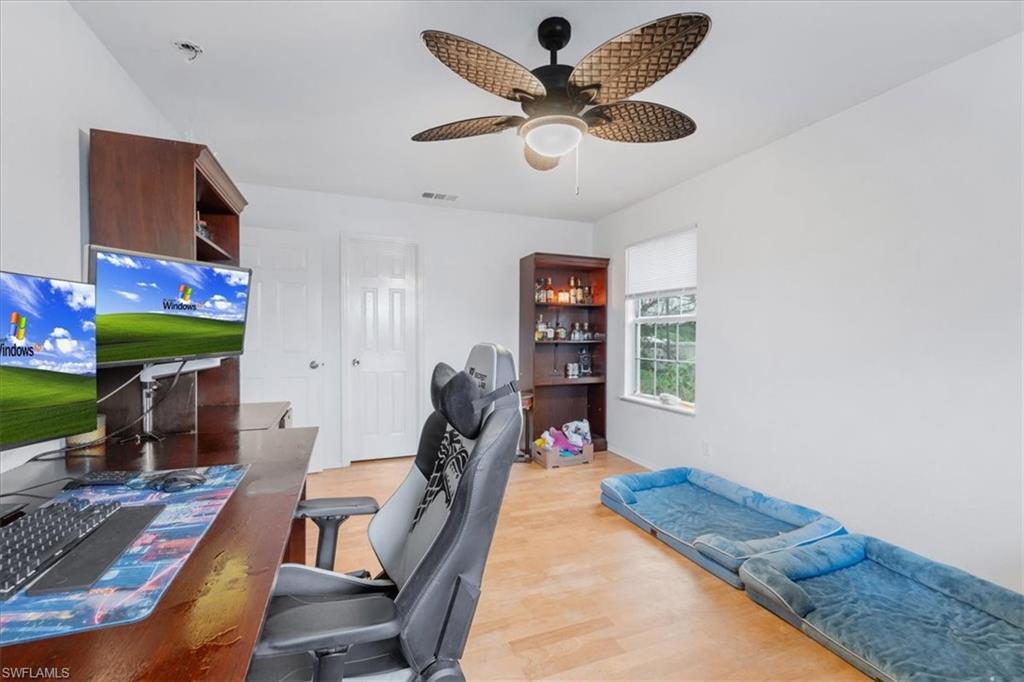 939 Church Avenue Naples, FL 34114 - Photo 11 of 31 a bedroom with furniture and a fireplace