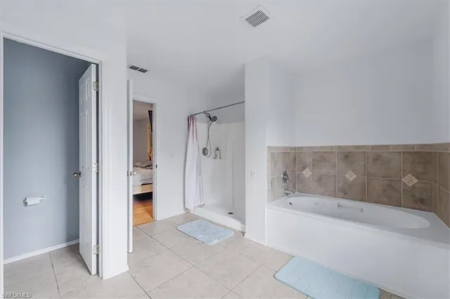 a bathroom with a bathtub and a shower
