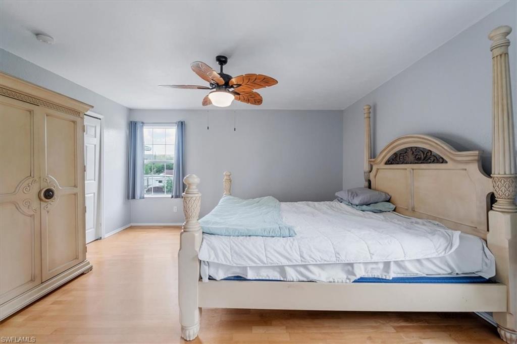 939 Church Avenue Naples, FL 34114 - Photo 22 of 31 a bedroom with a bed and a chandelier