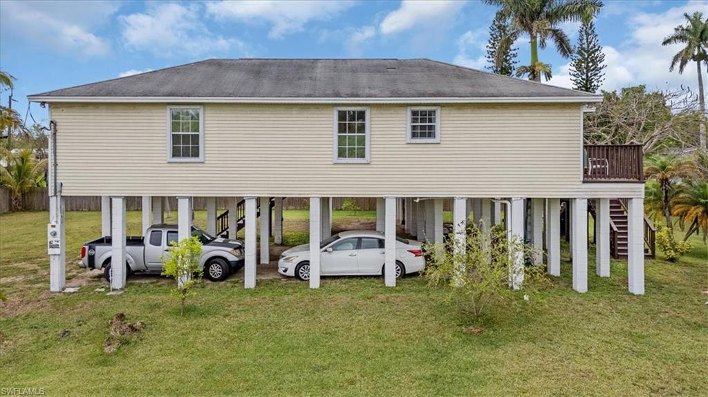 939 Church Avenue Naples, FL 34114 - Photo 27 of 31 a front view of a house with a garden and porch