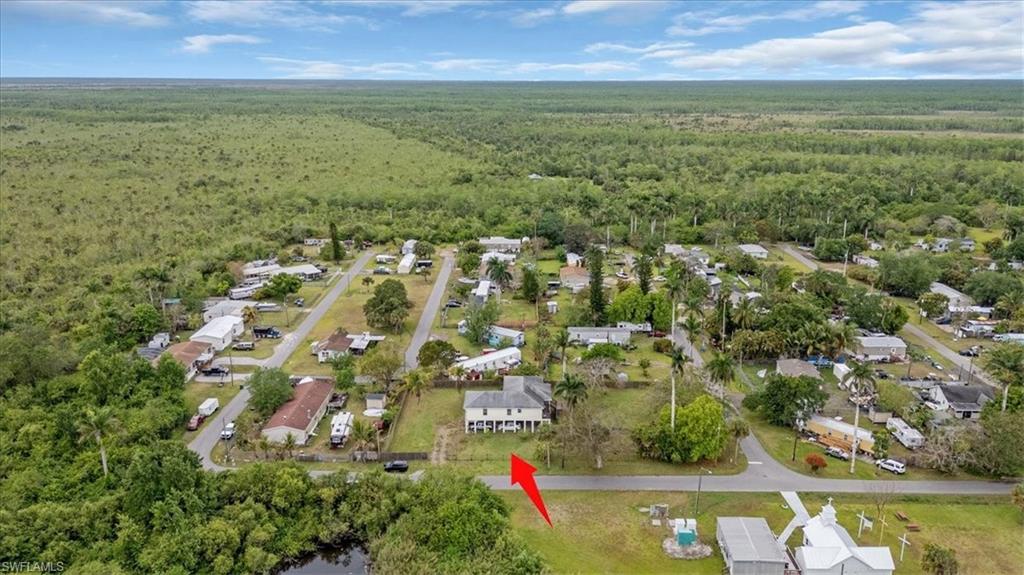 939 Church Avenue Naples, FL 34114 - Photo 30 of 31 an aerial view of residential houses with outdoor space and trees
