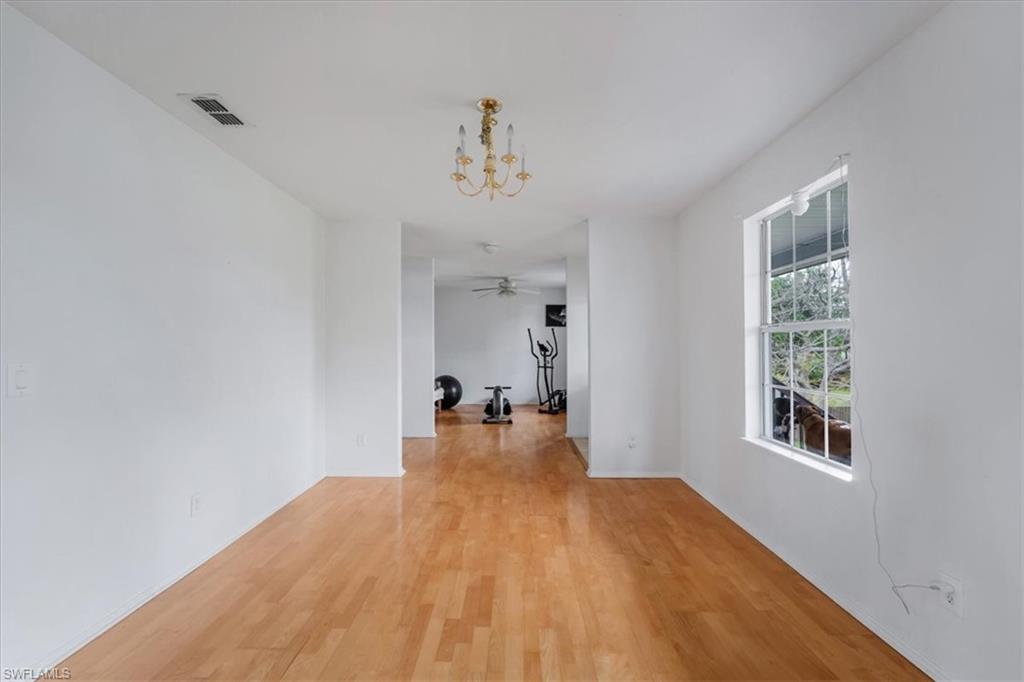 939 Church Avenue Naples, FL 34114 - Photo 7 of 31 wooden floor in an empty room with a window