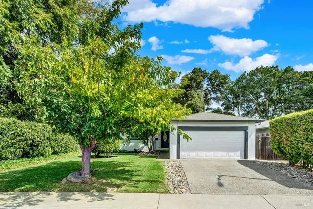 a front view of a house with a garden
