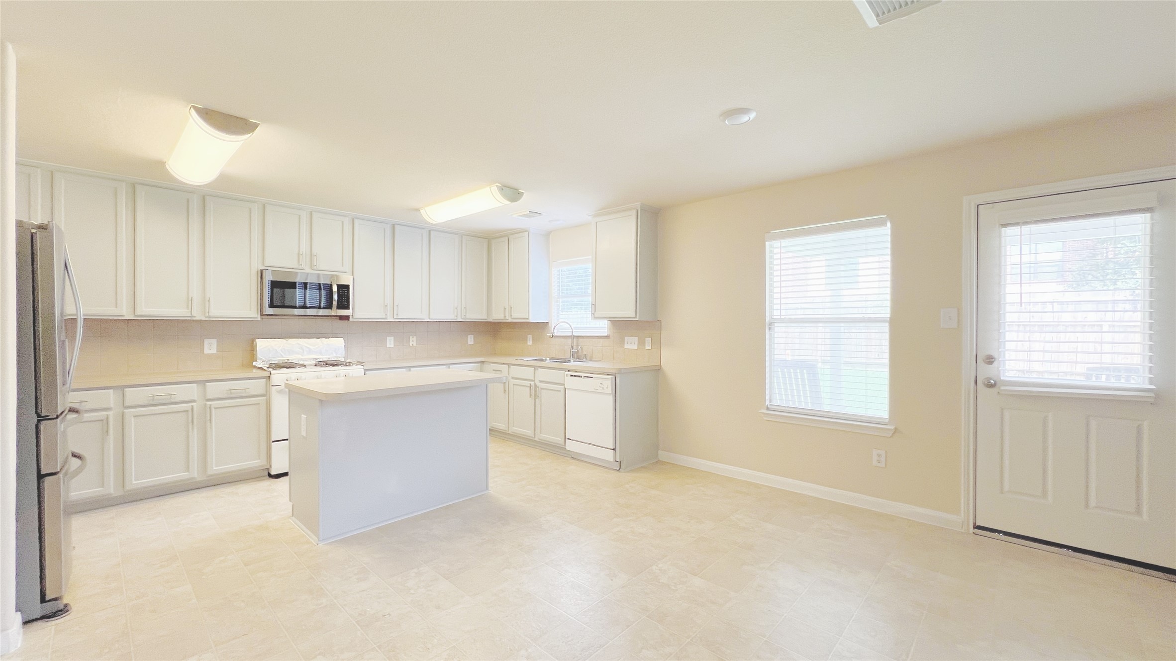 21338 Bella Mountain Drive Spring, TX 77379 - Photo 5 of 33 a kitchen with granite countertop white cabinets and white appliances