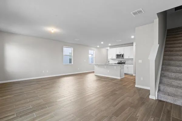 a view of kitchen with wooden floor and windows
