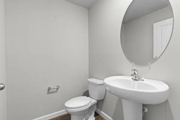 a bathroom with a sink toilet and a mirror