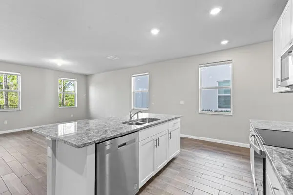 a kitchen with a sink stove and cabinets