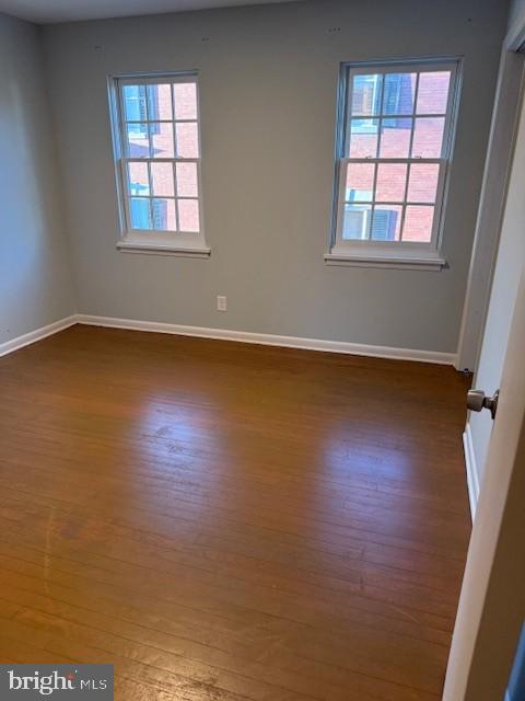 1103 Prince Edward Street, Unit 2 Fredericksburg, VA 22401 - Photo 5 of 7 an empty room with wooden floor and windows