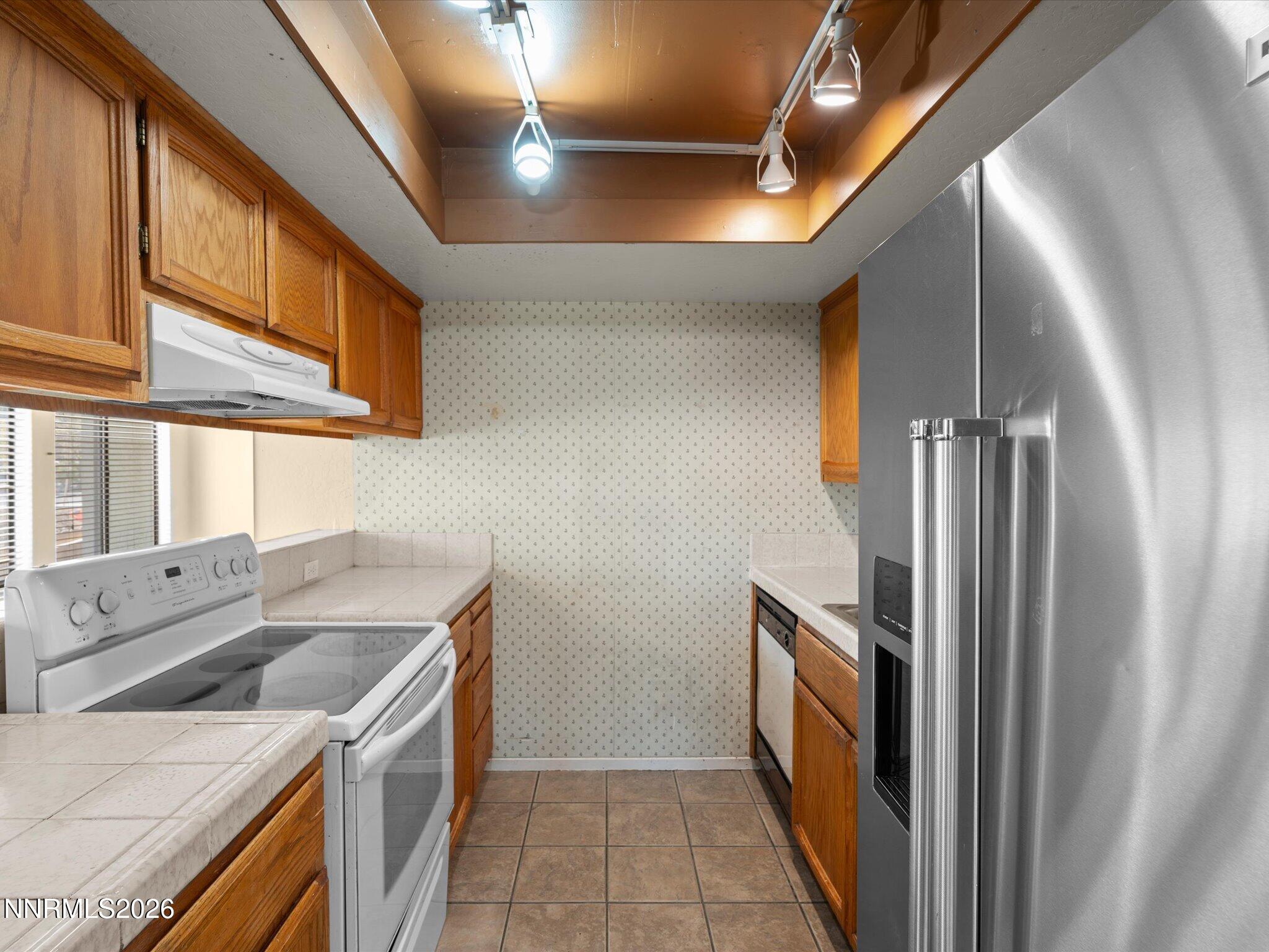 a kitchen with a refrigerator and a sink