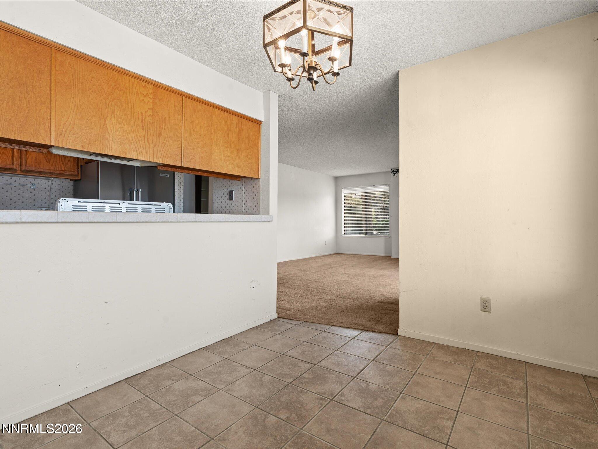 2845 Idlewild Drive, Unit 102 Reno, NV 89509 - Photo 13 of 44 a view of a hallway with a kitchen