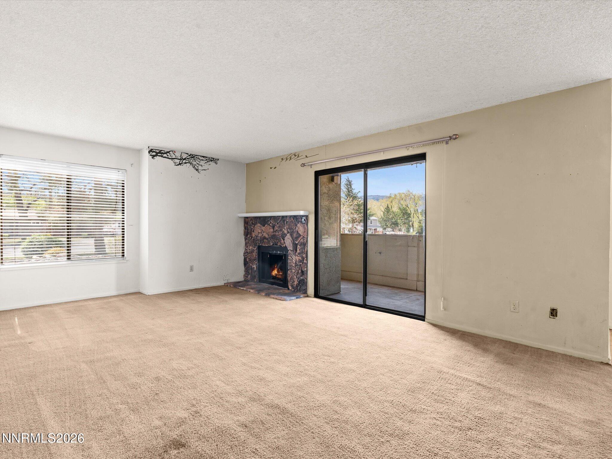 2845 Idlewild Drive, Unit 102 Reno, NV 89509 - Photo 14 of 44 an empty room with furniture and a fireplace