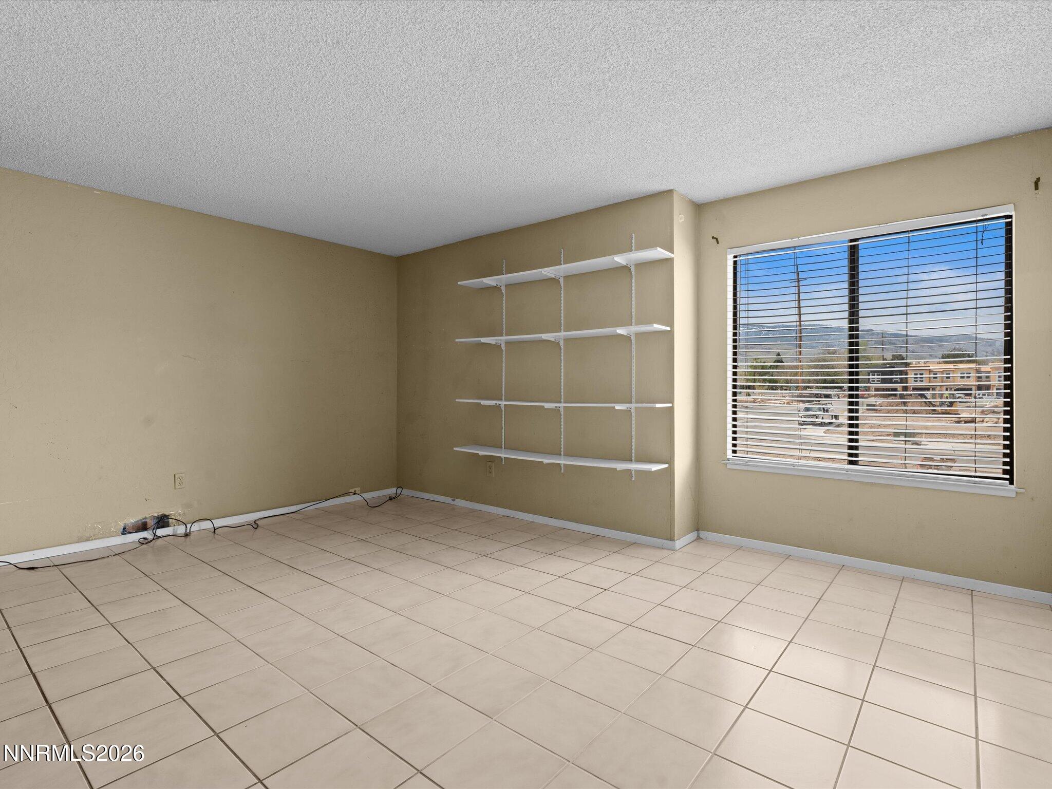 2845 Idlewild Drive, Unit 102 Reno, NV 89509 - Photo 15 of 44 a view of an empty room with a window