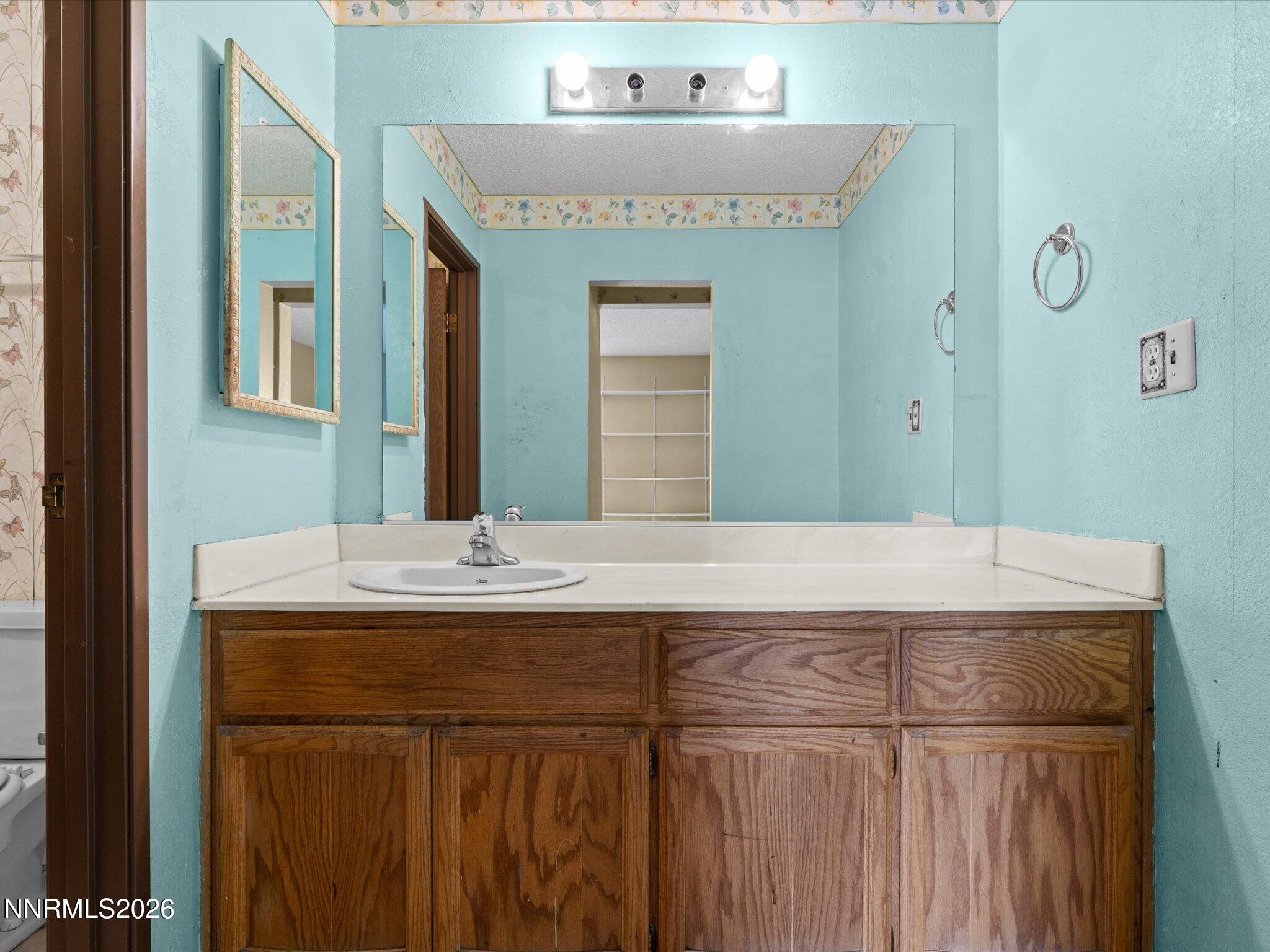 2845 Idlewild Drive, Unit 102 Reno, NV 89509 - Photo 18 of 44 a bathroom with a sink and a mirror