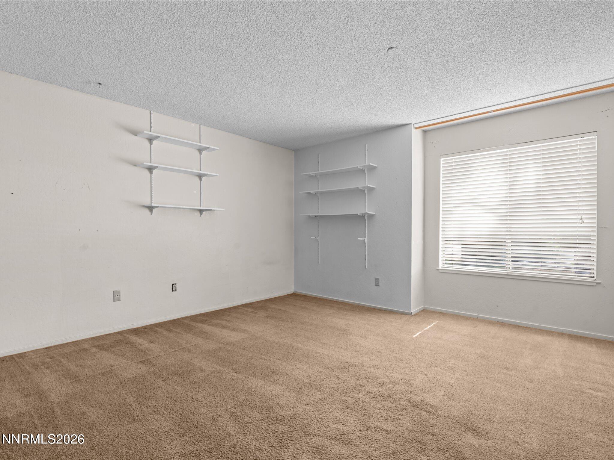 2845 Idlewild Drive, Unit 102 Reno, NV 89509 - Photo 22 of 44 a view of an empty room with a window