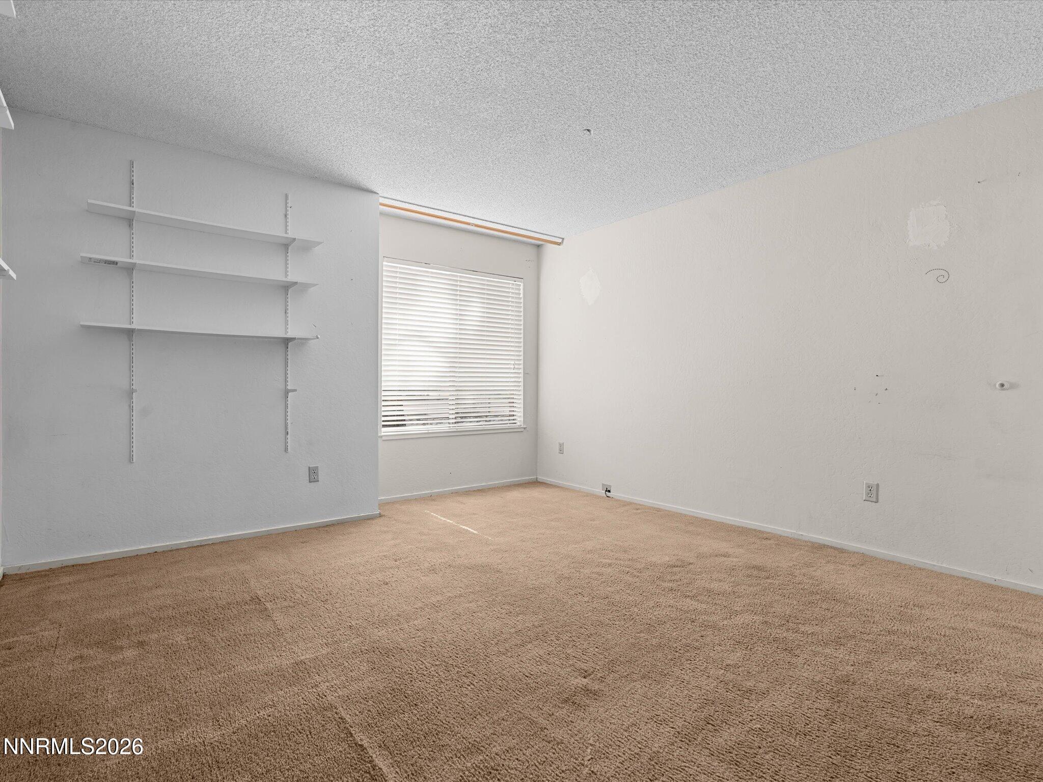 2845 Idlewild Drive, Unit 102 Reno, NV 89509 - Photo 23 of 44 a view of an empty room with a window