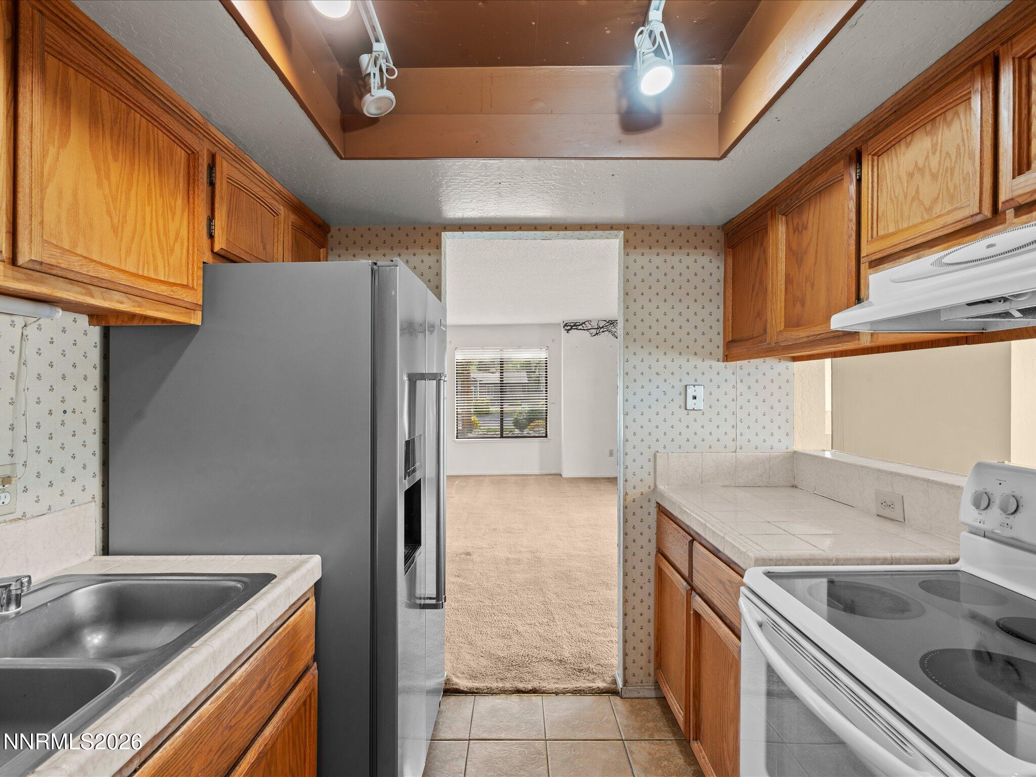 2845 Idlewild Drive, Unit 102 Reno, NV 89509 - Photo 7 of 44 a kitchen that has a sink and a stove