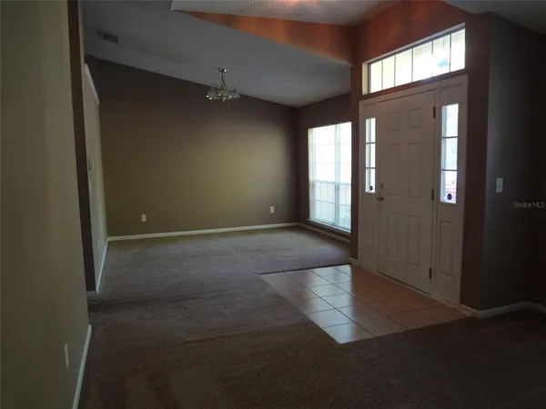 an empty room with windows and entrance