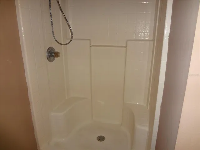 a bathroom with a glass shower door