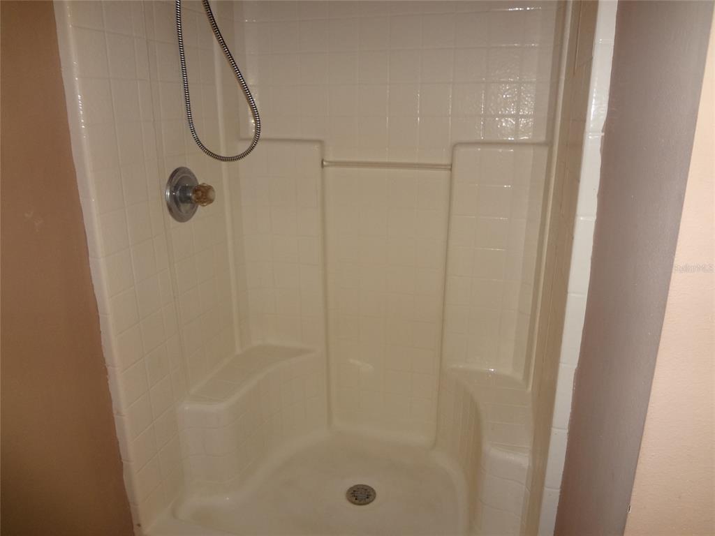 6 Buffalo Grove Drive Palm Coast, FL 32137 - Photo 21 of 24 a bathroom with a glass shower door