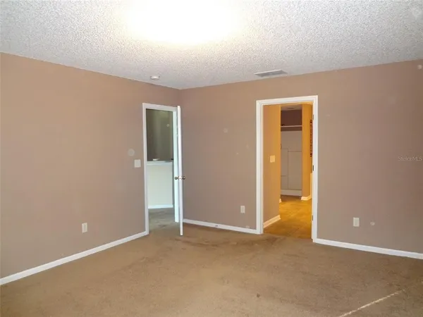 an empty room with closet area