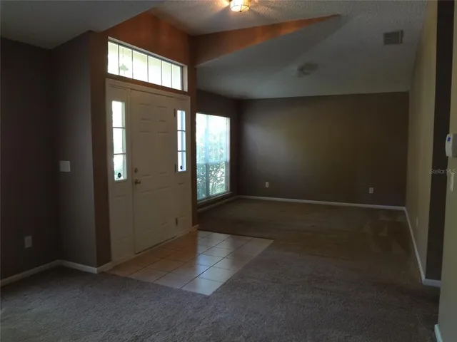 an empty room with windows and entrance