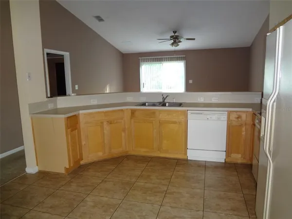 a view of a kitchen with microwave and cabinets