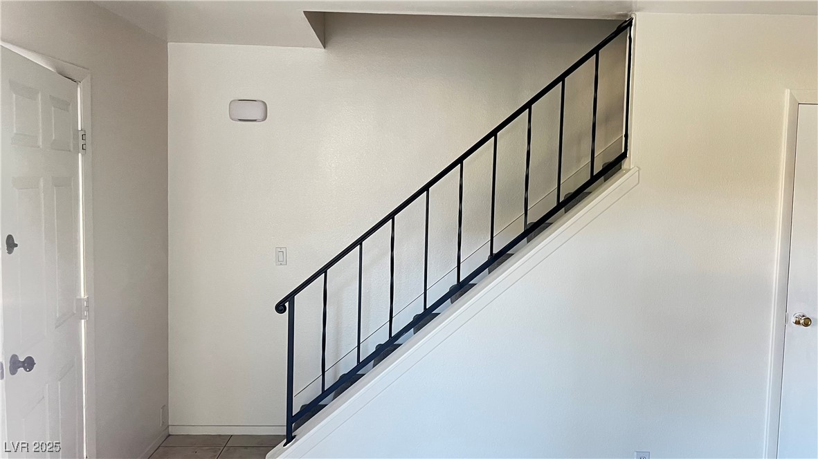 1441 Dorothy Avenue, Unit 2 Las Vegas, NV 89119 - Photo 7 of 20 Stairs with baseboards and tile patterned flooring