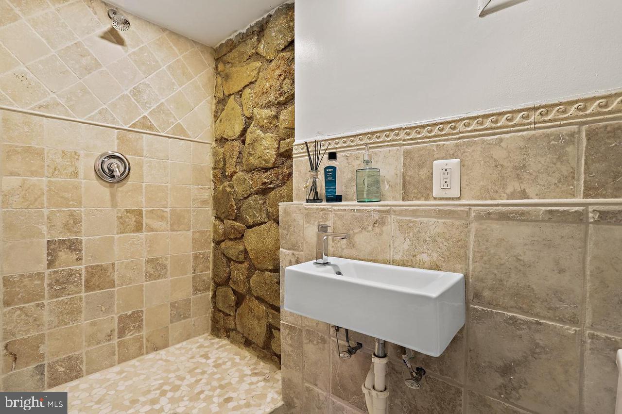 2347 South Arlington Ridge Road Arlington, VA 22202 - Photo 28 of 42 Stylish stone-accented shower retreat.