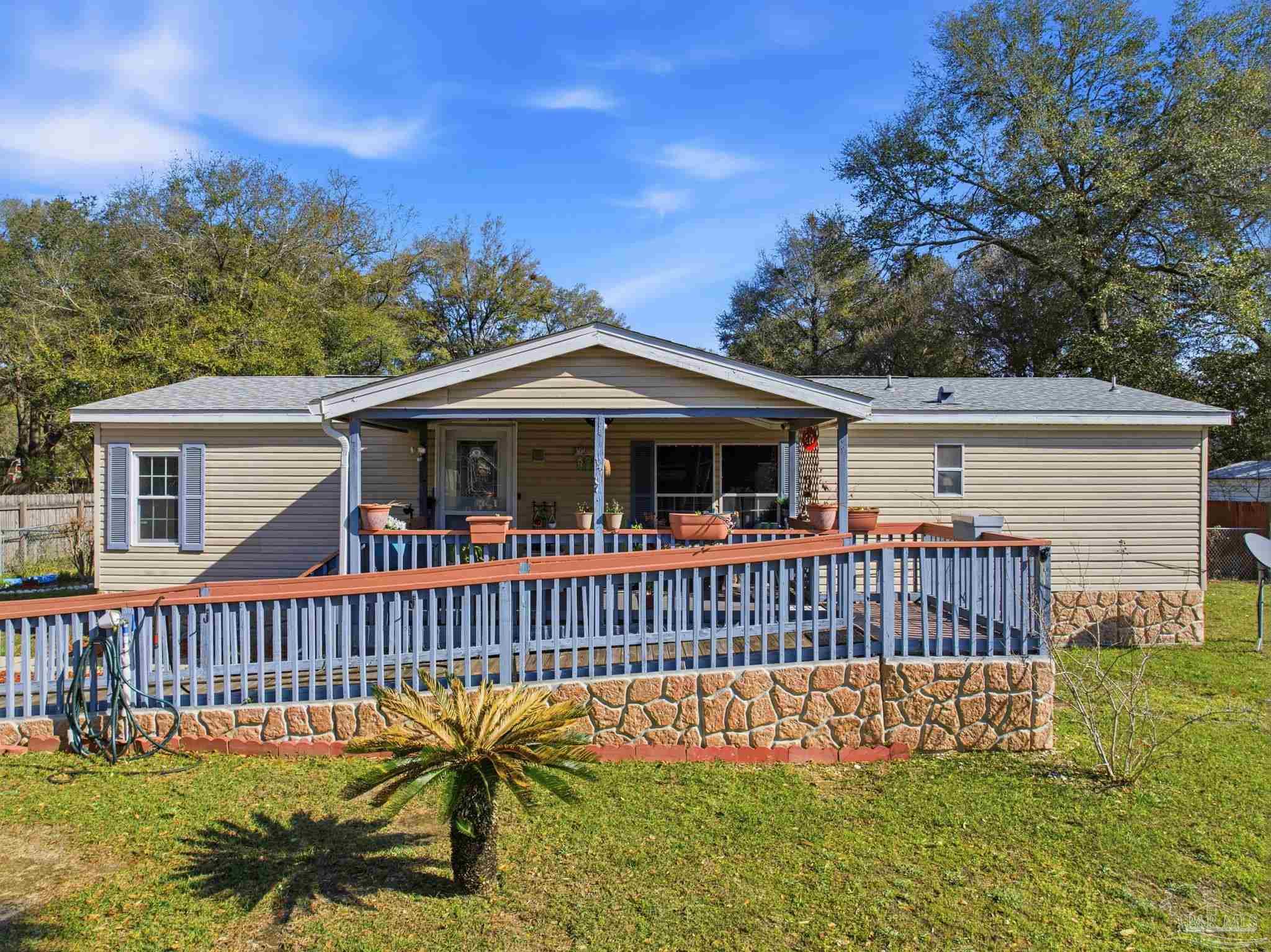 8962 Bluebell Street Milton, FL 32583 - Photo 1 of 35 a view of a house with a deck and a yard with swimming pool
