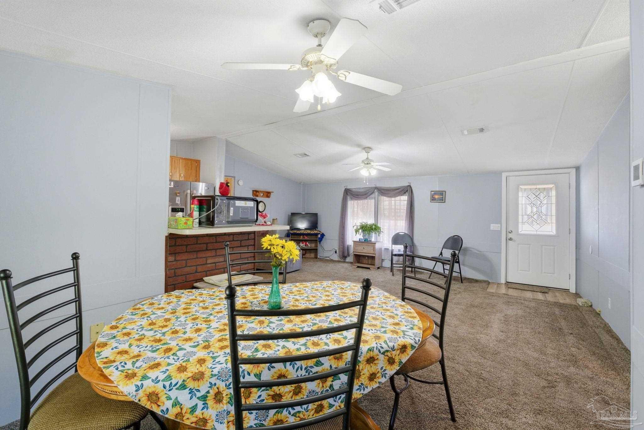 8962 Bluebell Street Milton, FL 32583 - Photo 11 of 35 a bedroom with a bed and chandelier