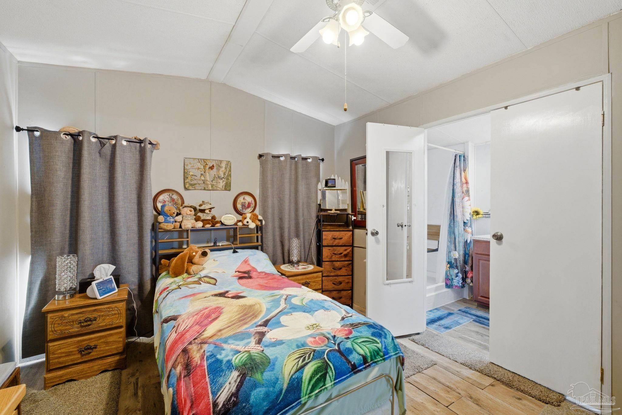 8962 Bluebell Street Milton, FL 32583 - Photo 16 of 35 a bedroom with bed and a large mirror