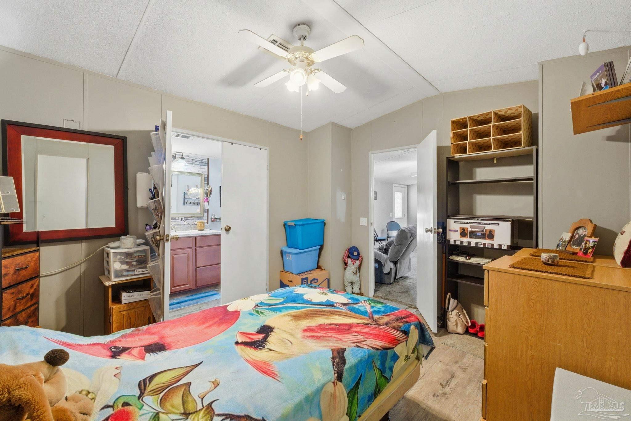 8962 Bluebell Street Milton, FL 32583 - Photo 17 of 35 a bedroom with a bed and a closet