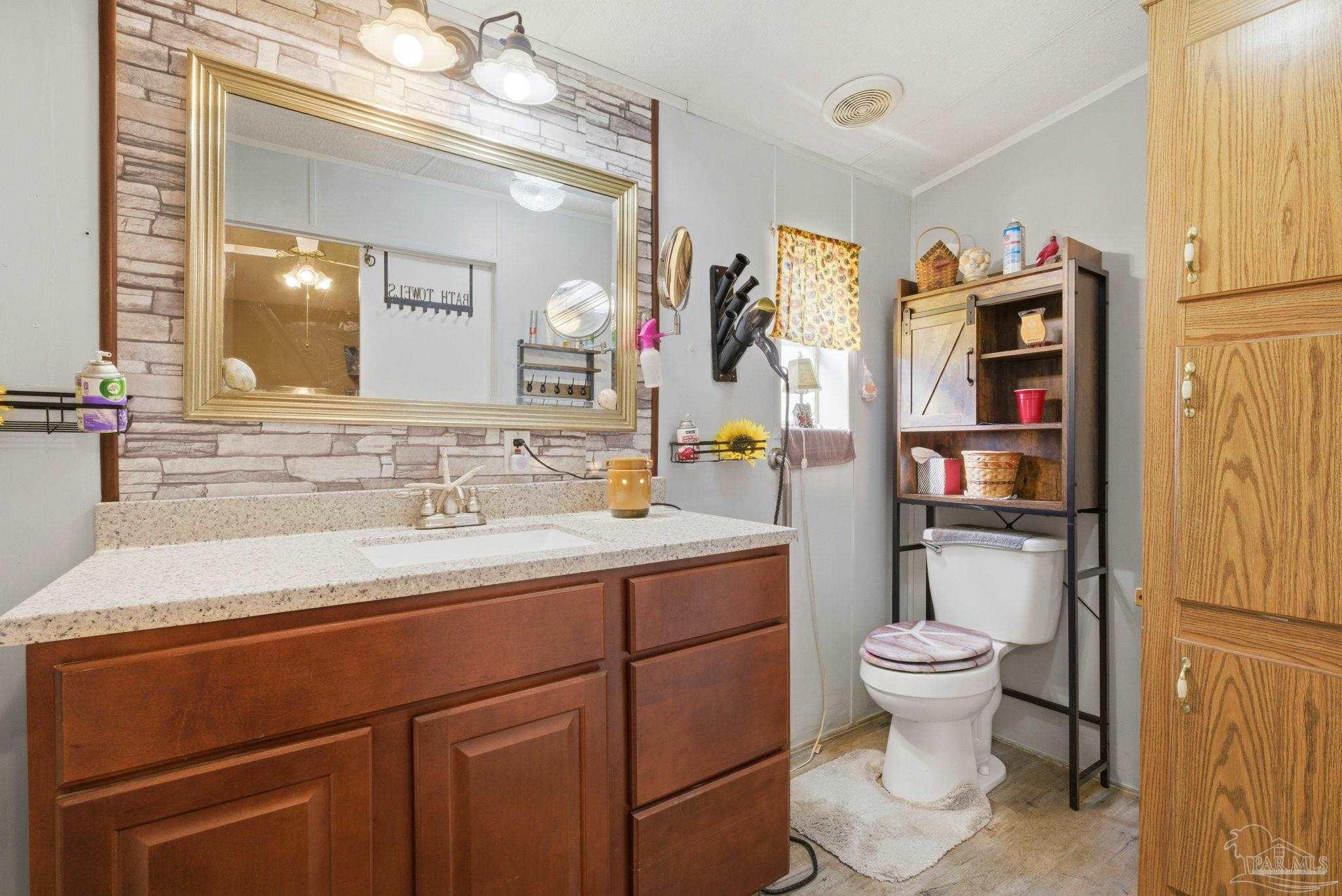 8962 Bluebell Street Milton, FL 32583 - Photo 18 of 35 a bathroom with a sink toilet and shower
