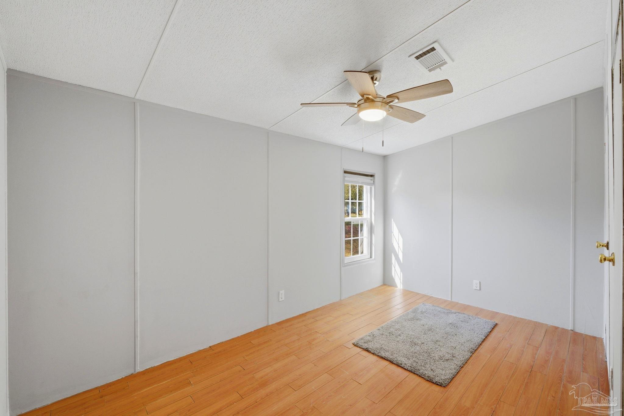8962 Bluebell Street Milton, FL 32583 - Photo 20 of 35 a view of a room with a ceiling fan and a window