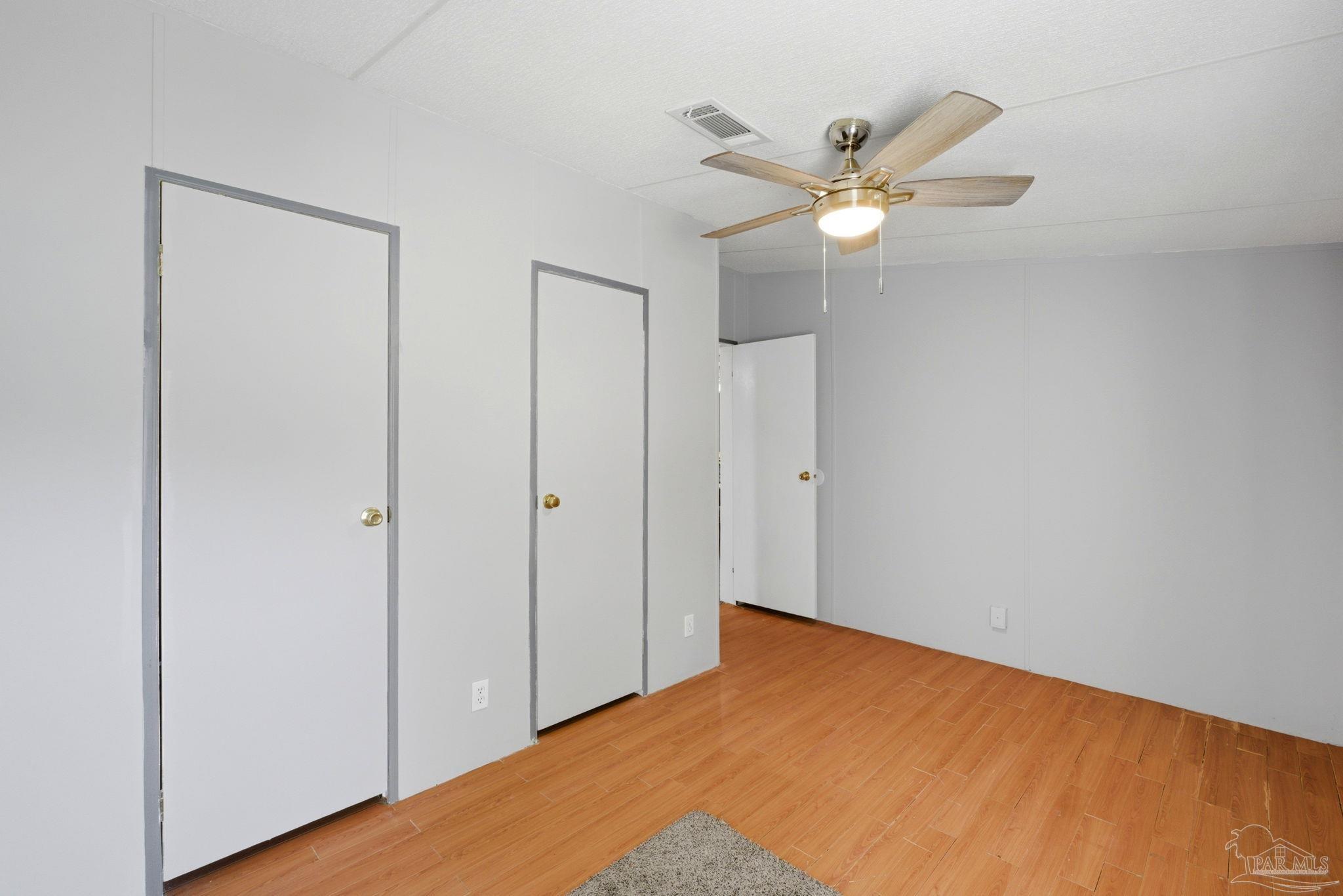 8962 Bluebell Street Milton, FL 32583 - Photo 21 of 35 a view of a workspace with wooden floor and a ceiling fan