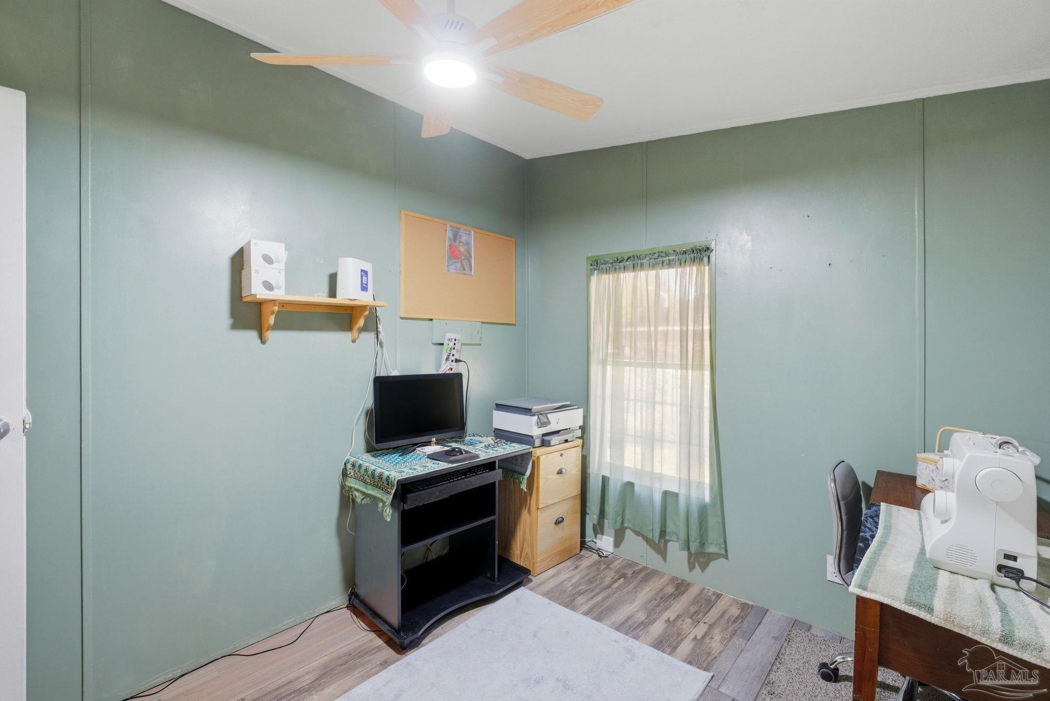 8962 Bluebell Street Milton, FL 32583 - Photo 24 of 35 a view of a workspace with furniture and a window