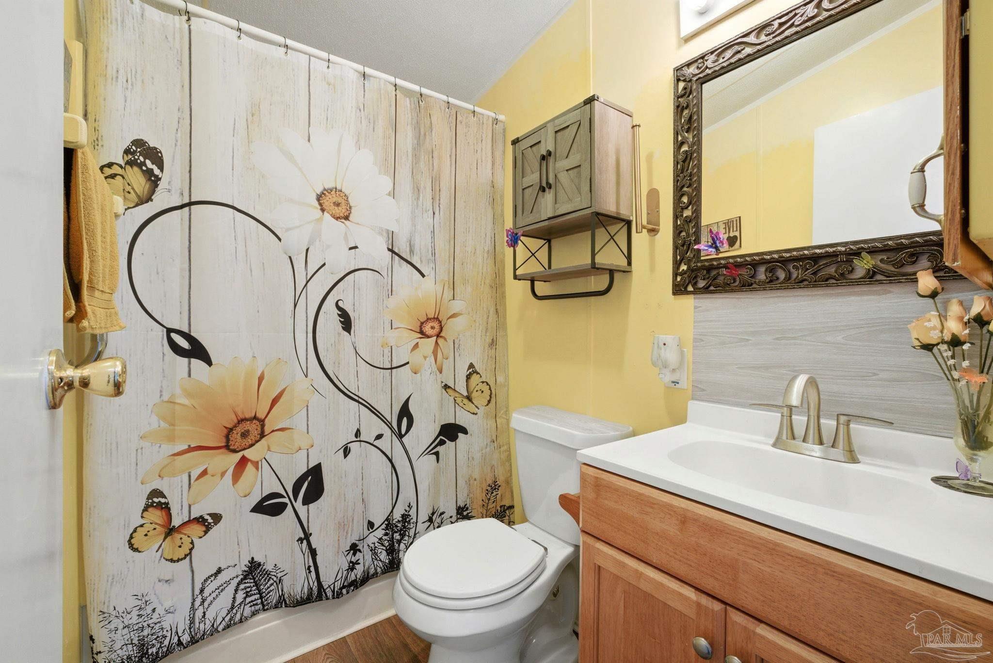 8962 Bluebell Street Milton, FL 32583 - Photo 26 of 35 a bathroom with a toilet sink and mirror