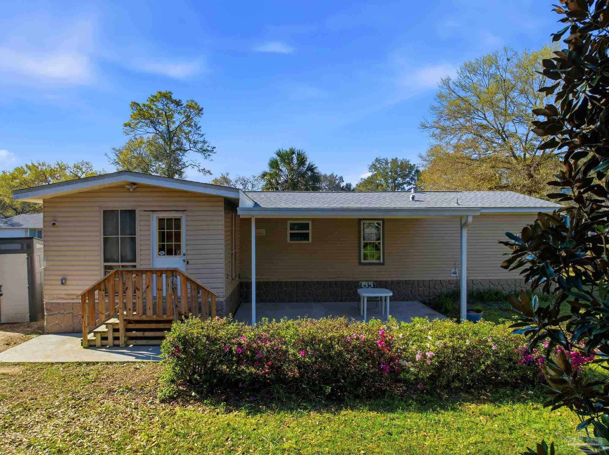 8962 Bluebell Street Milton, FL 32583 - Photo 31 of 35 a view of a house with a garden