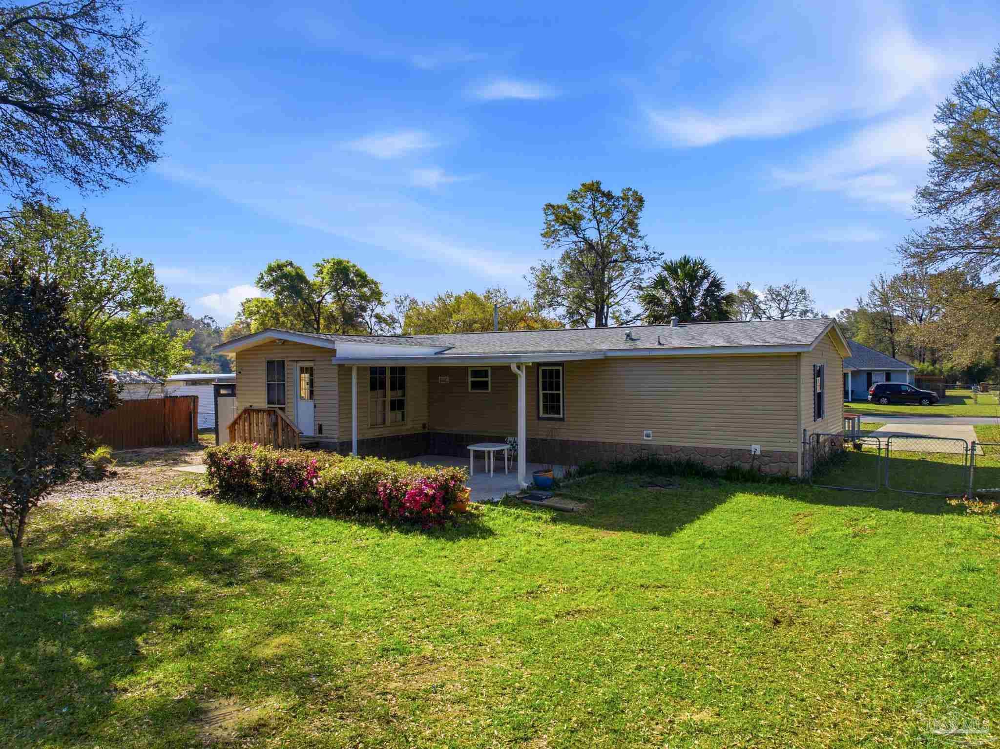 8962 Bluebell Street Milton, FL 32583 - Photo 33 of 35 a front view of house with yard and outdoor seating