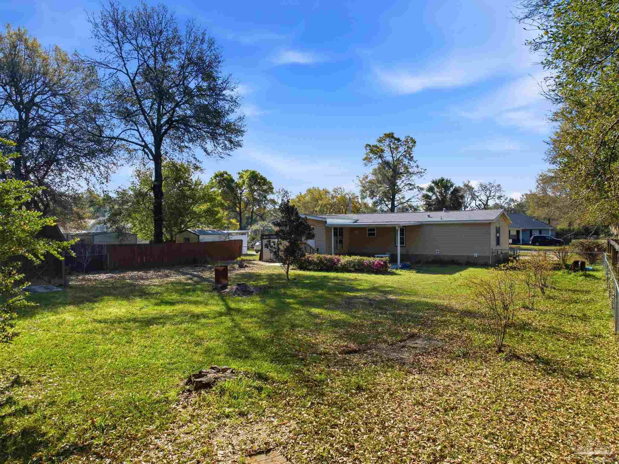 8962 Bluebell Street Milton, FL 32583 - Photo 34 of 35 a view of a house with a backyard