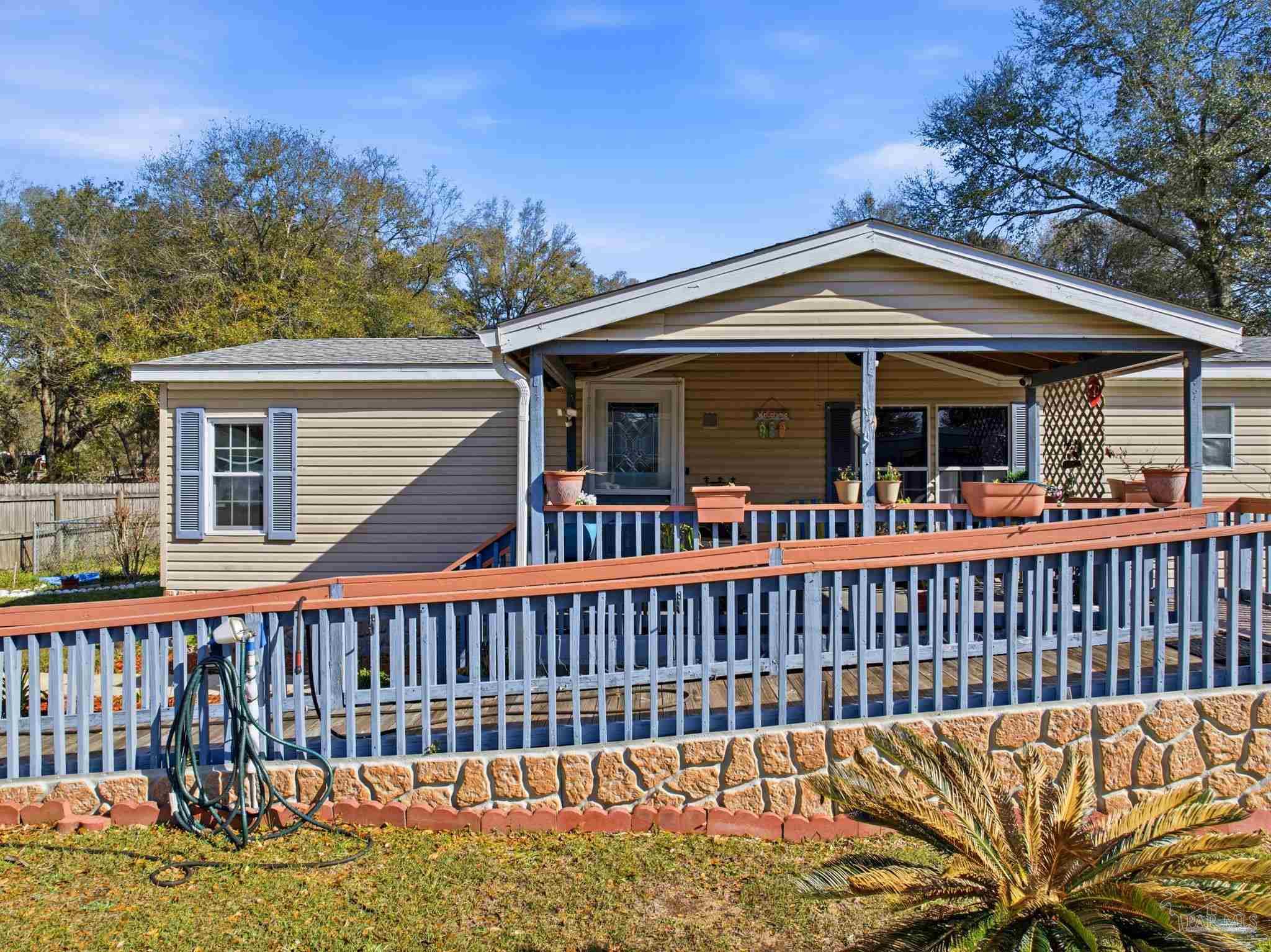 8962 Bluebell Street Milton, FL 32583 - Photo 4 of 35 a view of a house with a wooden deck