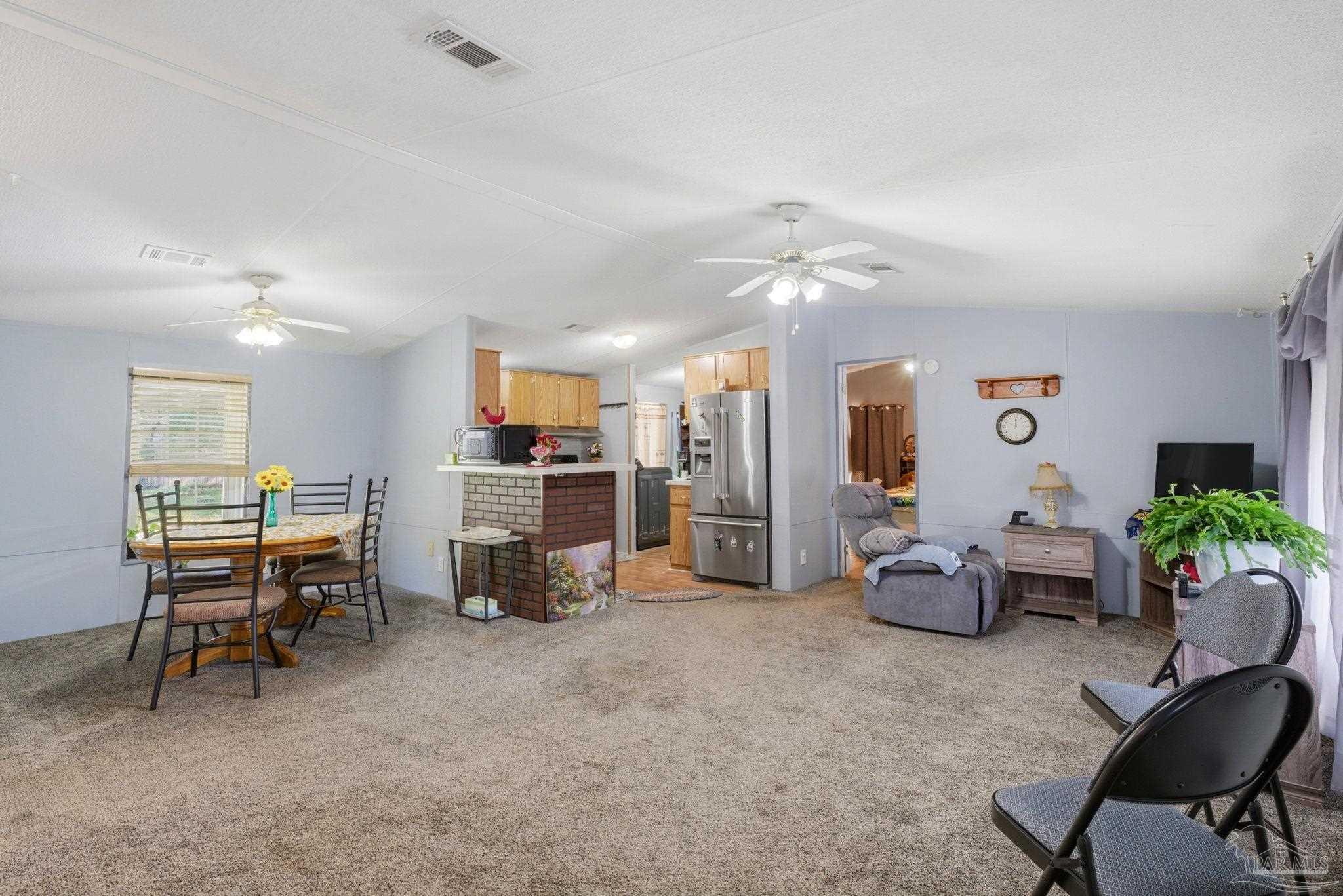 8962 Bluebell Street Milton, FL 32583 - Photo 7 of 35 a living room with furniture and a flat screen tv
